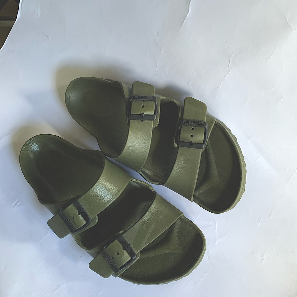 Army Green with black scraps Birkenstock sandals. Open toes and open back.